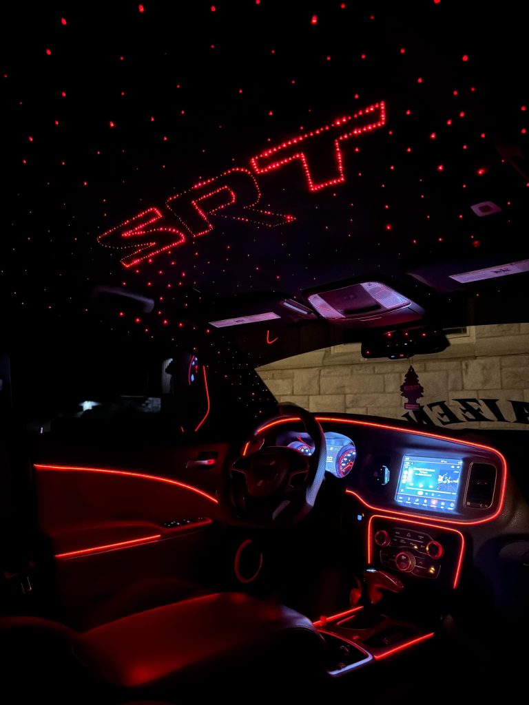 Infotainment screen inside a car glowing purple